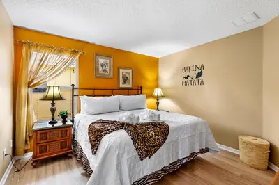 a bedroom with a bed and a window at Disney Doorstep 7 Bedroom Villa with SouthFacing Pool and Hot Tub in Kissimmee