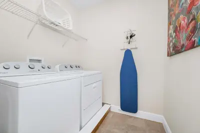 a kitchen with a white stove and a blue vase on the wall at Welcoming Home With Game Room And Private Pool With Water Park Access At Encore Resorts Reunion - 150Mn in Kissimmee