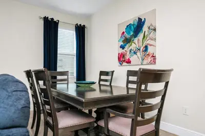 a dining room with a table and chairs at Welcoming Home With Game Room And Private Pool With Water Park Access At Encore Resorts Reunion - 150Mn in Kissimmee
