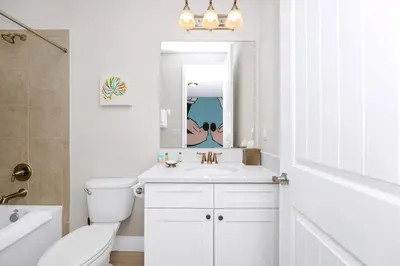 a white bathroom with a sink and a toilet at Marvelous Home With Media Room, Theme Room And Waterpark & Resort Access Near Disney At Encore Resorts Reunion - 7485Mr in Kissimmee