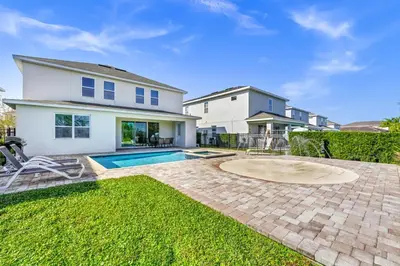 a house with a swimming pool in the yard at Marvelous Home With Media Room, Theme Room And Waterpark & Resort Access Near Disney At Encore Resorts Reunion - 7485Mr in Kissimmee