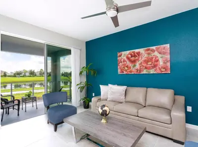 a living room with a couch and a table at Amazing Townhome With Lake View At Storey Lake Resort in Kissimmee