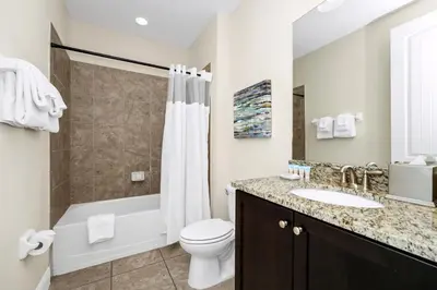 a bathroom with a toilet and a sink and a shower at Extravagant Home With Movie Theater, Private Pool And Waterpark & Resort Access At Encore Resort - 241Fl in Kissimmee