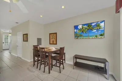 a dining room with a table and chairs at Perfect Townhome Near Disney in Orlando