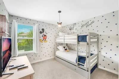 a childs bedroom with a bunk bed and a desk at Cozy home in the best location of orlando in Kissimmee