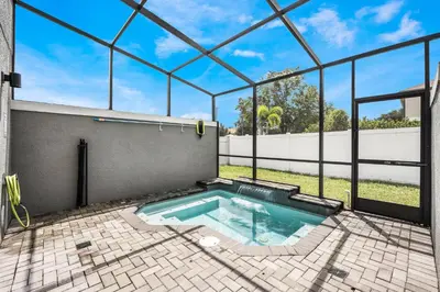 a swimming pool in a house with a glass ceiling at Cozy home in the best location of orlando in Kissimmee