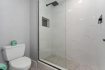 a bathroom with a toilet and a glass shower at Spacious 1BR near Universal I-Drive in Orlando