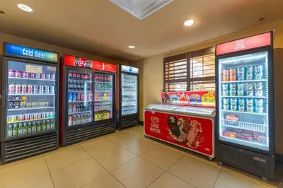 a store with two refrigerators in a grocery store at Spacious 1BR near Universal I-Drive in Orlando