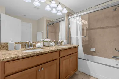 a bathroom with a sink and a shower at Upstay Family Home w Resort Access & Private Pool in Kissimmee
