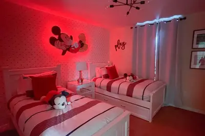 a bedroom with two beds with red lights at Upstay Family Home w Resort Access & Private Pool in Kissimmee