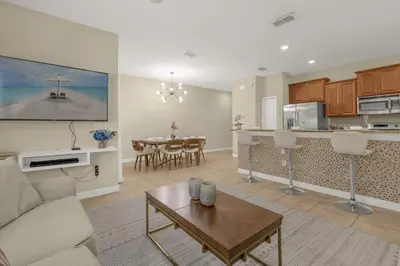 a living room with a couch and a table at Upstay Family Home w Resort Access & Private Pool in Kissimmee