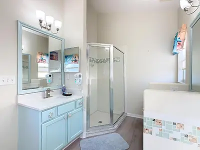 a bathroom with a shower and a sink at 4BR home w pool, spa & BBQ grill in Orlando