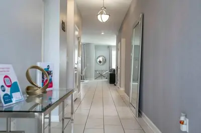 a hallway with a tile floor and a hallway with a mirror at Villa 6Q Storey Lake – 10 min da Disney in Kissimmee
