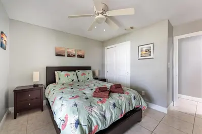 a bedroom with a bed and a ceiling fan at 9 min to Disney Entrance-Peaceful Single Family House in Kissimmee
