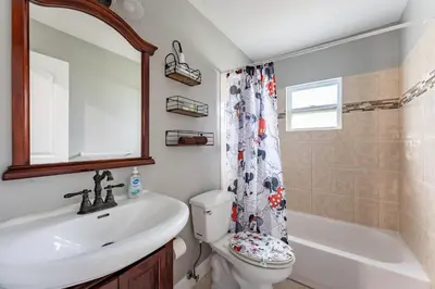 a bathroom with a sink and a toilet and a shower at 9 min to Disney Entrance-Peaceful Single Family House in Kissimmee