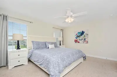 a bedroom with a bed and a ceiling fan at Wonderful 4Bd with Pool at Storey Lake Resort 4819 in Kissimmee