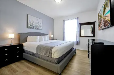 a bedroom with a large bed and a window at Luxury Epic Universe Condo, Vista Cay - 3028 in Orlando
