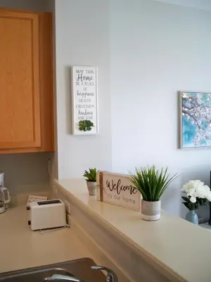 a kitchen counter with plants and a sign that reads welcome to our home at Lovely Vacation Home with 3 bedrooms! in Kissimmee