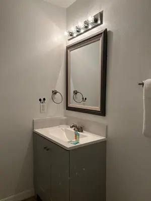 a bathroom with a sink and a mirror at Lovely Vacation Home with 3 bedrooms! in Kissimmee