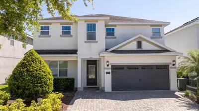 a house with a garage in front of it at Fantastic 5BR Villa Near Disney - Priv. Pool SPA in Orlando