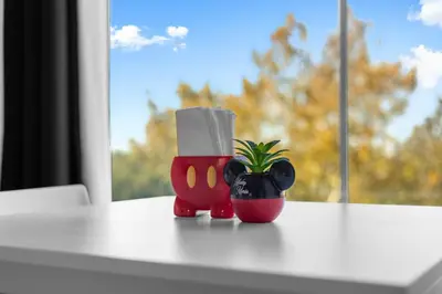 a table with a plant and a container with a paper roll at King Bed Theme Park Hotel Free Shuttle Included in Orlando
