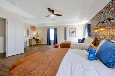a bedroom with two beds and a ceiling fan at Lilo & Stitch Themed Villa 10 Min to Disney! Heated Pool & Game Room in Orlando