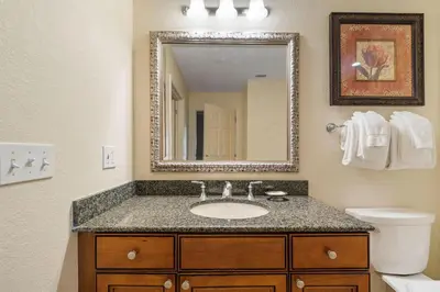 a bathroom with a sink and a mirror at Villas North Charm in Orlando