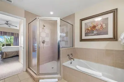 a bathroom with a shower and a bath tub at Villas North Charm in Orlando