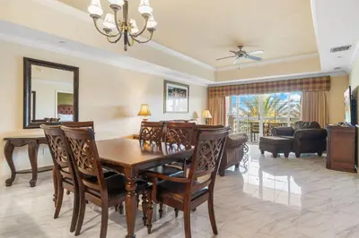 a dining room with a table and chairs and a living room at Villas North Charm in Orlando