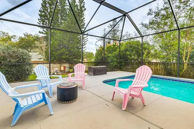 a group of chairs and a table and a pool at Swim, Golf and Relax Lovely Home in Lake Mary in Lake Mary