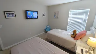 a bedroom with two beds and a teddy bear on the bed at Spectacular Lake View - Game Room- Close to Disney in Kissimmee