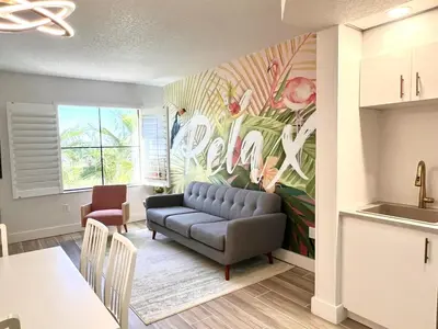 a living room with a couch and a painting on the wall at Unit near Epic Universe and Universal Studios - free parking in Orlando