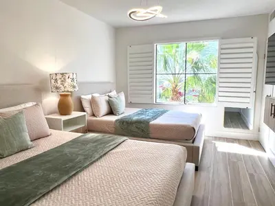 a bedroom with two beds and a window at Unit near Epic Universe and Universal Studios - free parking in Orlando