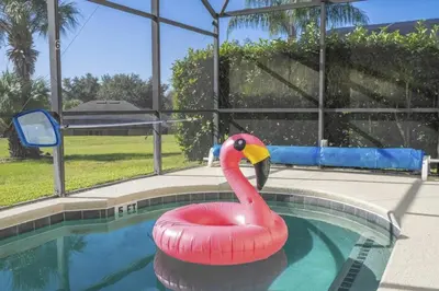 a pink flamingo float in a swimming pool at Sunshine Escape 20 minutes from Disney in Kissimmee
