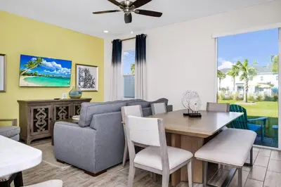 a living room with a couch and a table and chairs at Tranquil Villa Near Disney With Margaritaville Resort & Island H20 Waterpark Access - 2928Cs in Orlando
