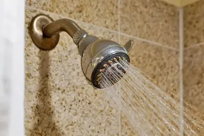 a shower head with water coming out of it at Disney Dream Condo & Lake View Awaits! in Orlando