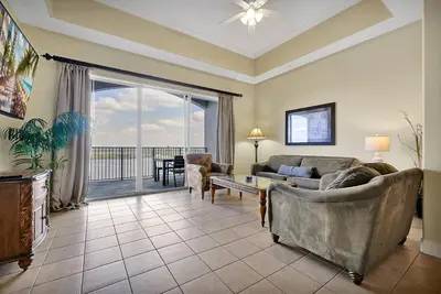 a living room with a couch and a table at Living the Disney Dream! Lake View Luxury Condo in Orlando