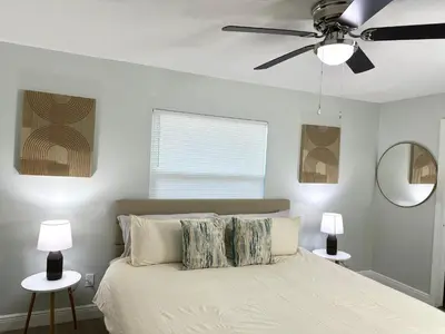 a bedroom with a bed with a ceiling fan at Orlando Luxe Retreat with Private Pool in Orlando