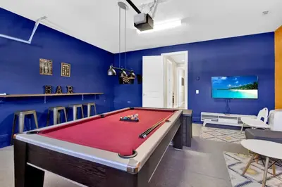 a pool table in a room with blue walls at Relaxing 6BR Home w Pool Near Disney in Orlando