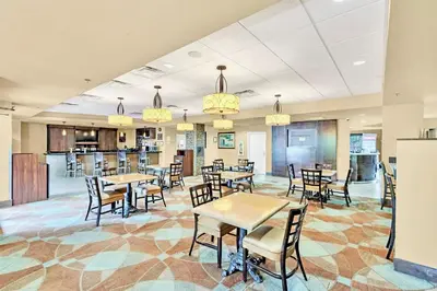 a restaurant with tables and chairs and a bar at Condo w Pool Hot Tub - Close to Universal Studios in Orlando