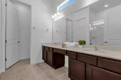 a bathroom with a sink and a large mirror at Beautiful and cozy at Veranda Palms in Kissimmee