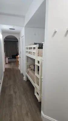 a hallway with two bunk beds in a room at Orlando 12th Floor - 5 min Disney in Orlando