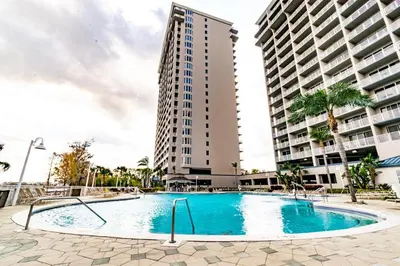 a swimming pool in front of two tall buildings at Orlando 12th Floor - 5 min Disney in Orlando