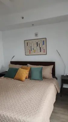 a bed with several pillows on top of it at Orlando 12th Floor - 5 min Disney in Orlando