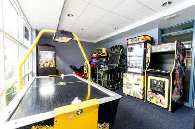 a room with a ping pong table and arcade games at Orlando Blue Heron 1 Mile From Disney 2nd floor in Orlando