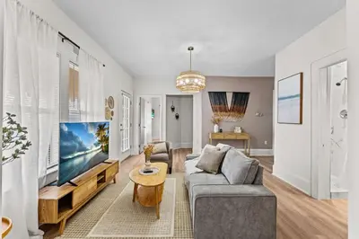 a living room with a couch and a tv at SUPER BOHO - LAKE TOHO FISHiNG WATER FRONTs in Kissimmee