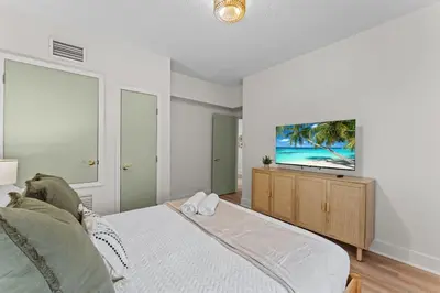 a bedroom with a bed and a flat screen tv at SUPER BOHO - LAKE TOHO FISHiNG WATER FRONTs in Kissimmee