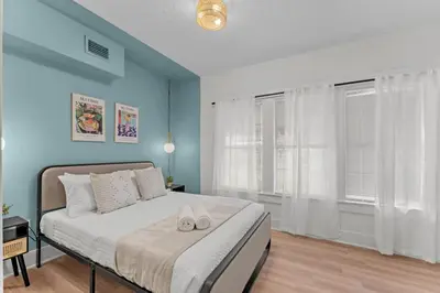 a bedroom with a bed with two shoes on it at SUPER BOHO - LAKE TOHO FISHiNG CIVIC CeNTER in Kissimmee
