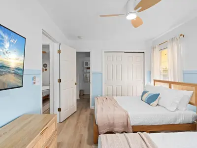 a bedroom with a bed and a ceiling fan at SUPER BOHO- At LAKE TOHO's WATER SLEEPs 6 in Kissimmee