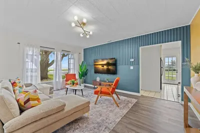 a living room with a couch and a table at SUPER BOHO - At Lake Toho Fishing VINTaGE VIBEs in Kissimmee
